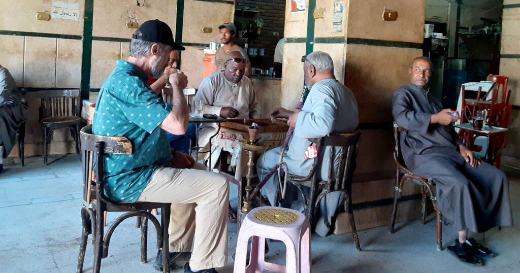 Men sipping tea, smoking shish and playing backgammon